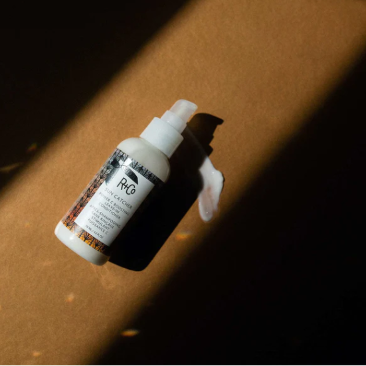 White bottle with a pump on a brown surface