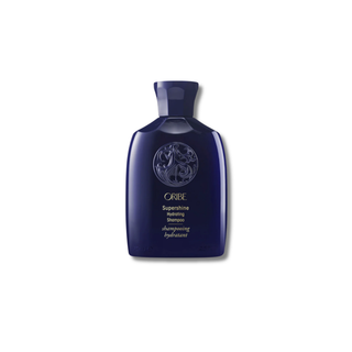 Blue Oribe shampoo bottle on a white background