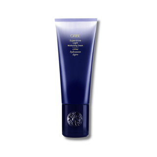 Blue tube of Oribe Supershine Light Moisturizing Cream on a white background