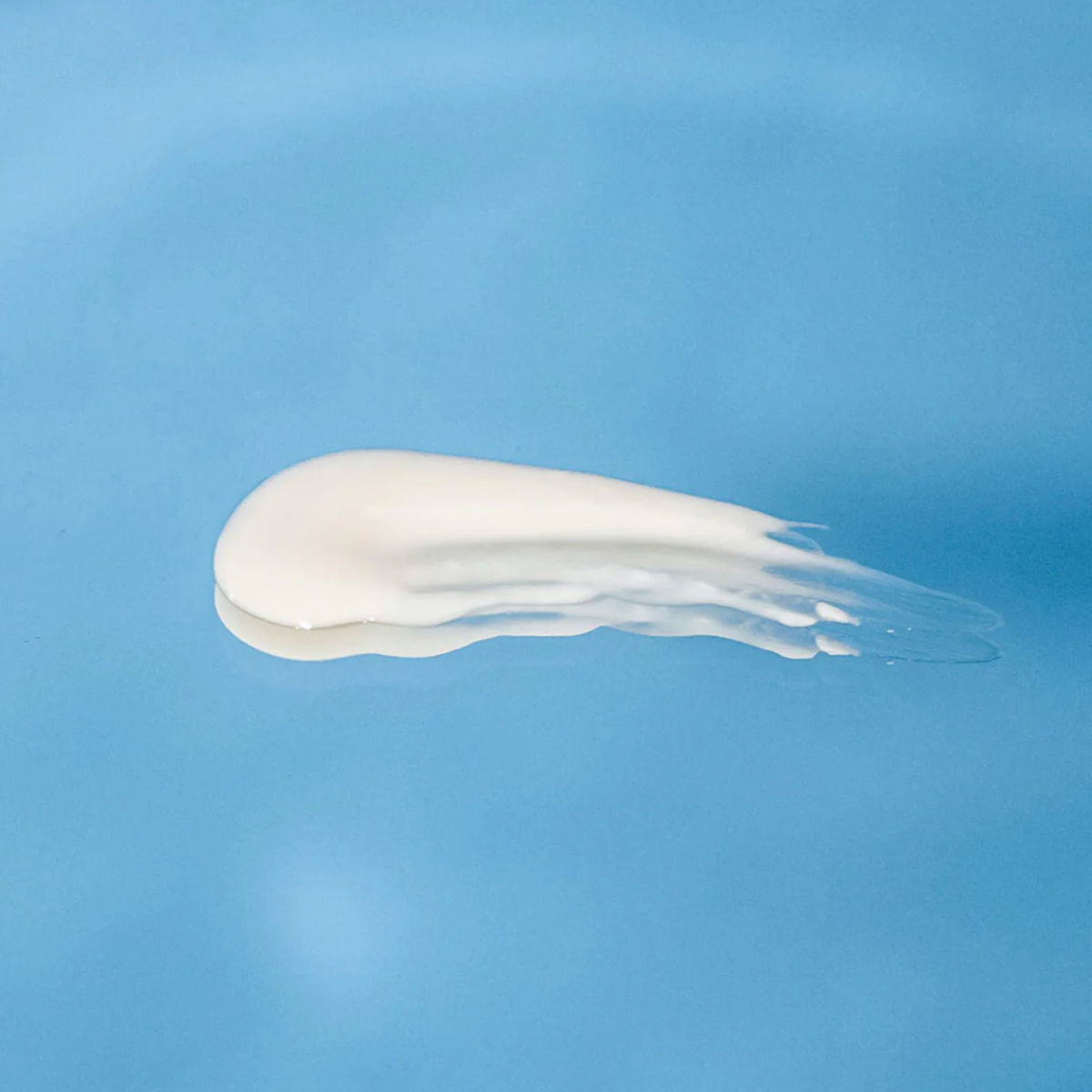 White cream smear on a blue background