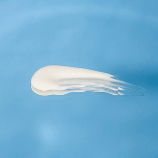 White cream smear on a blue background