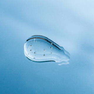 Close-up of a skincare product smear on a blue background